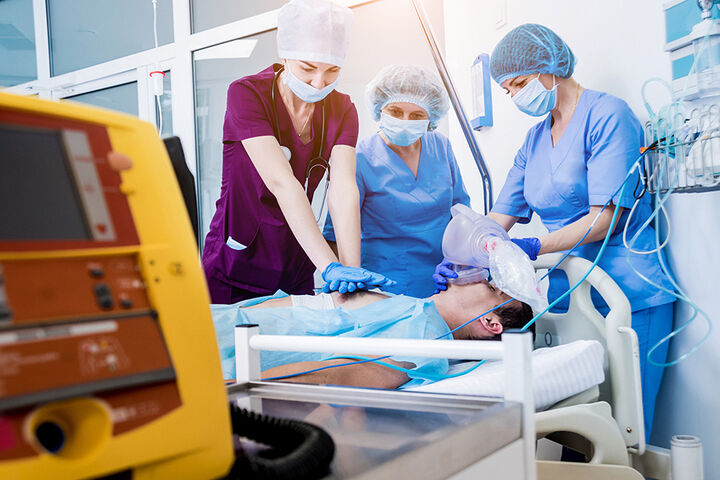 Doctors give resuscitation to a male patient in the emergency room.